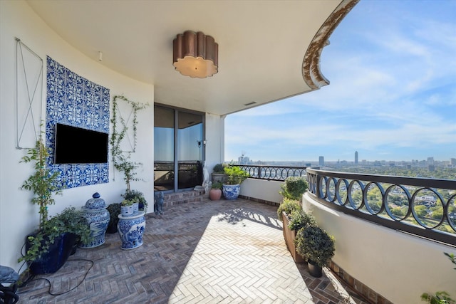 view of patio featuring a balcony and a city view