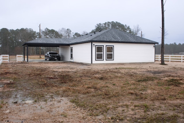 exterior space with a carport and fence