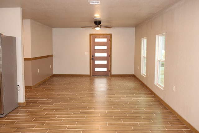 foyer featuring baseboards, a ceiling fan, and wood tiled floor