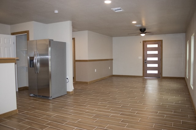 kitchen with ceiling fan, wood finish floors, stainless steel refrigerator with ice dispenser, and visible vents