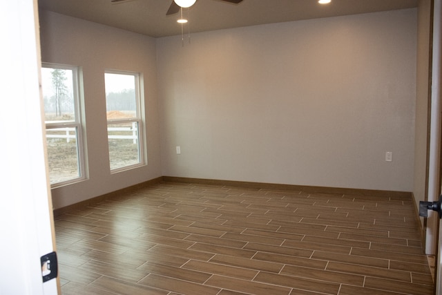 empty room featuring recessed lighting, baseboards, a ceiling fan, and wood finish floors