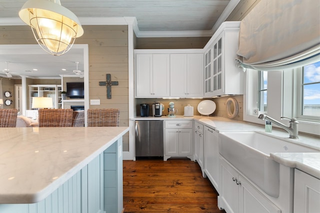 kitchen featuring glass insert cabinets, refrigerator, white cabinets, and light stone counters