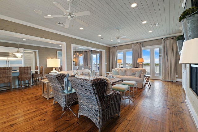 living room featuring ornamental molding, wooden ceiling, visible vents, and wood finished floors