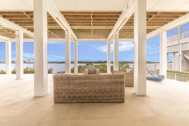 view of patio / terrace with a water view and an outdoor living space