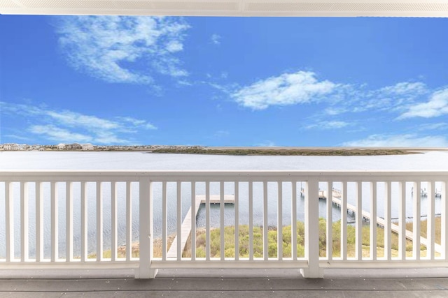 deck with a water view and a beach view