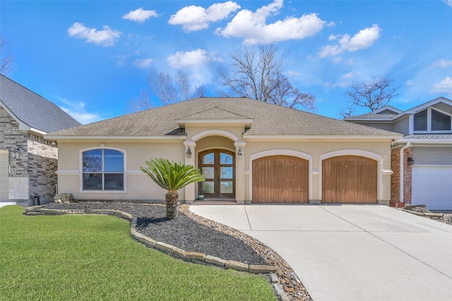 ranch-style home with concrete driveway, roof with shingles, an attached garage, a front lawn, and stucco siding