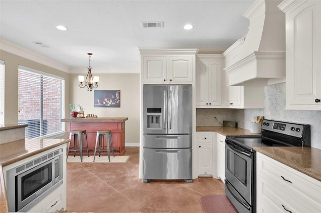 kitchen with decorative backsplash, white cabinets, appliances with stainless steel finishes, custom exhaust hood, and crown molding