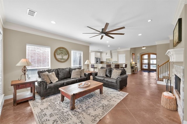 living area featuring french doors, a fireplace, recessed lighting, visible vents, and baseboards