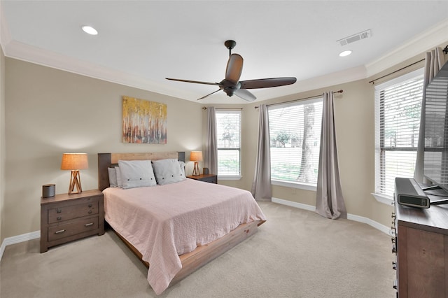 bedroom featuring multiple windows, visible vents, light colored carpet, and ornamental molding