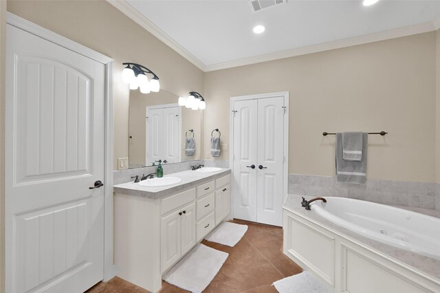 full bath featuring a tub with jets, tile patterned flooring, a sink, and crown molding