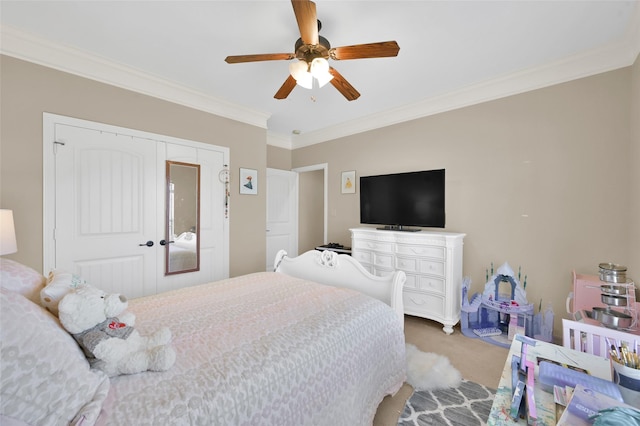 carpeted bedroom featuring a closet, a ceiling fan, and crown molding