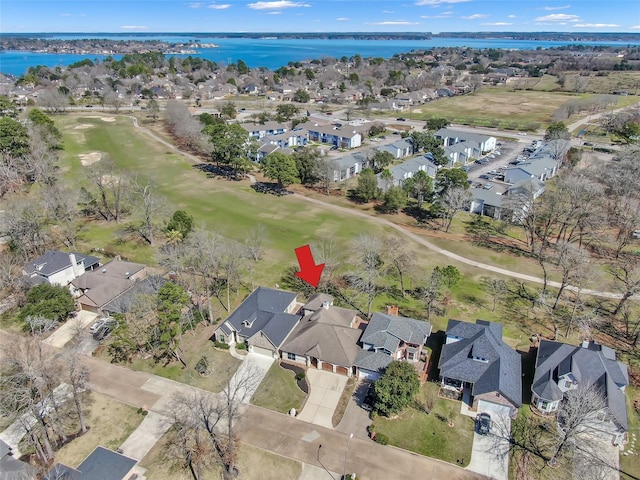 birds eye view of property with a water view and a residential view