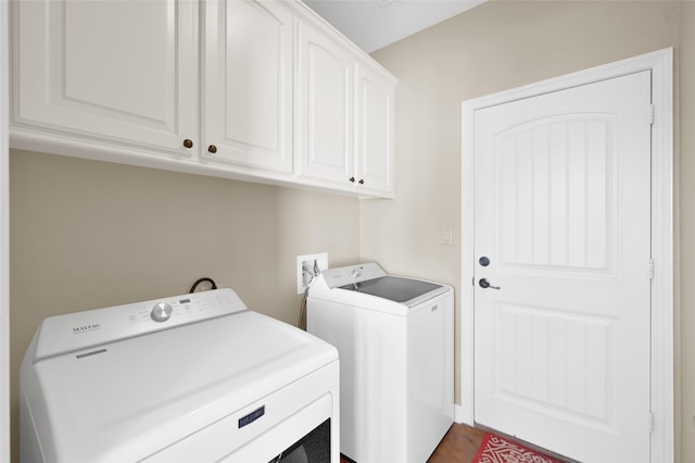 washroom featuring cabinet space and separate washer and dryer