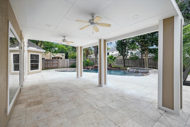 view of patio / terrace featuring a fenced backyard, a pool with connected hot tub, and a ceiling fan