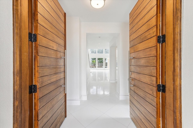 corridor featuring light tile patterned floors