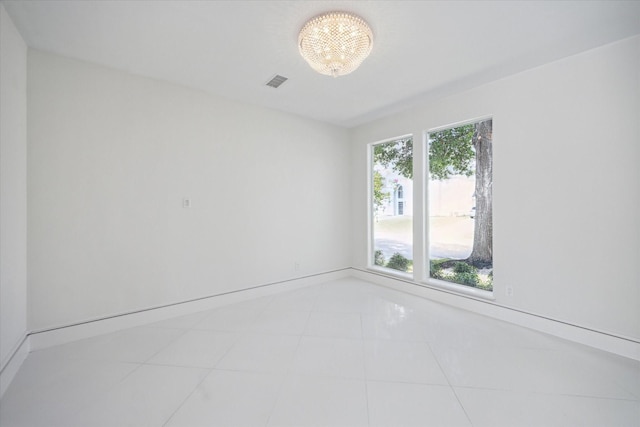 empty room featuring light tile patterned floors and visible vents