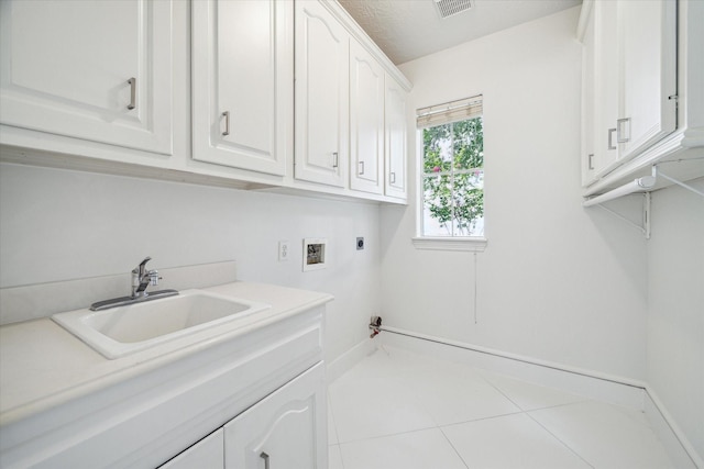 washroom featuring cabinet space, visible vents, hookup for an electric dryer, washer hookup, and a sink