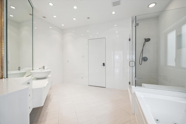 bathroom with double vanity, a stall shower, visible vents, a tub with jets, and recessed lighting