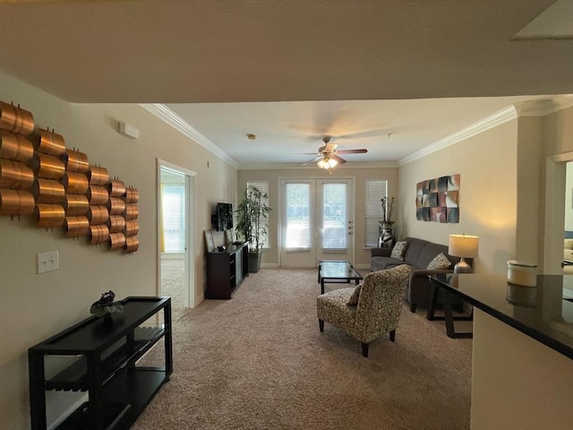 living area featuring ceiling fan, ornamental molding, and light colored carpet