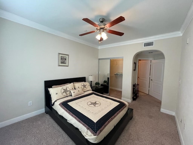 bedroom featuring arched walkways, light colored carpet, visible vents, ornamental molding, and baseboards