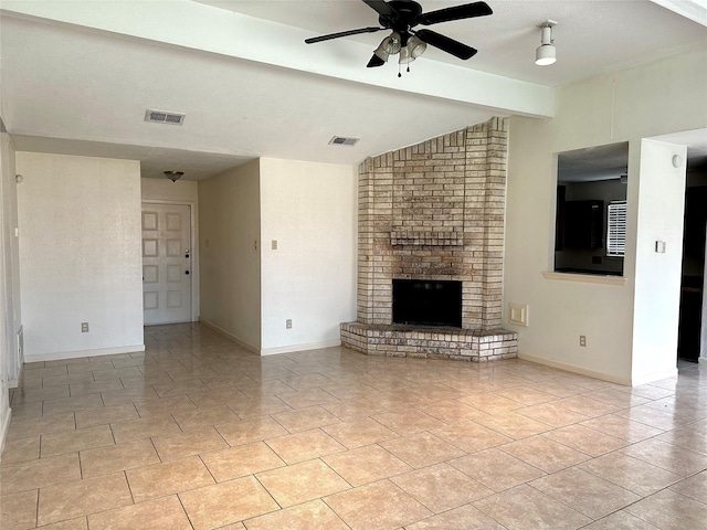 unfurnished living room with light tile patterned floors, lofted ceiling with beams, a fireplace, and visible vents