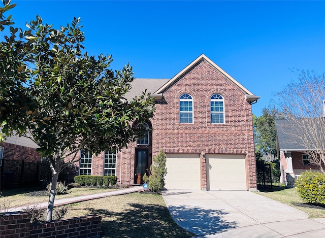 traditional-style house with driveway, a garage, and brick siding