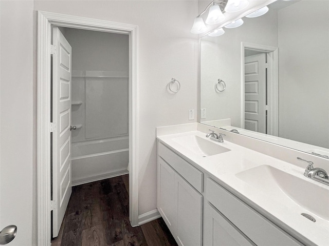 27407 Axis Deer Trl, Magnolia, TX 77354 - full bathroom featuring a sink, double vanity, shower / washtub combination, and wood finished floors
