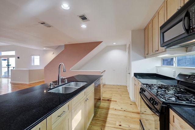 kitchen with light wood finished floors, visible vents, light brown cabinetry, black appliances, and a sink