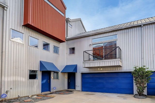 view of property with concrete driveway and an attached garage