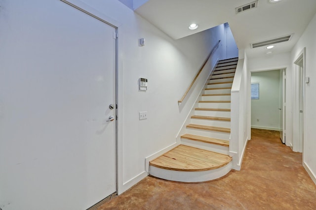 staircase featuring recessed lighting, visible vents, and unfinished concrete floors