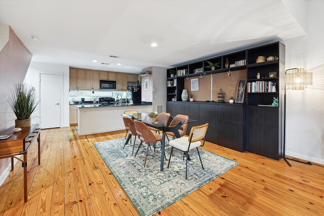 dining space featuring light wood-type flooring, visible vents, baseboards, and recessed lighting