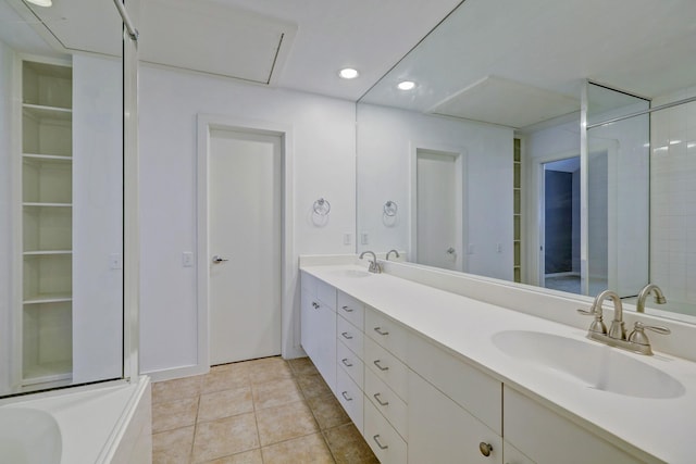 bathroom featuring recessed lighting, double vanity, a sink, and tile patterned floors