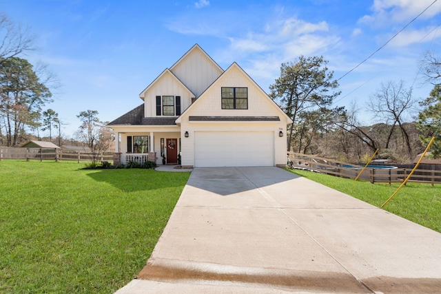 modern inspired farmhouse with a garage, a front yard, driveway, and fence