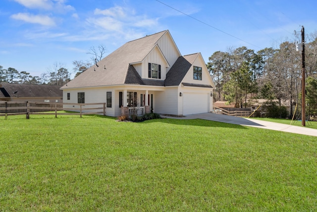 modern farmhouse with covered porch, driveway, a front lawn, and fence