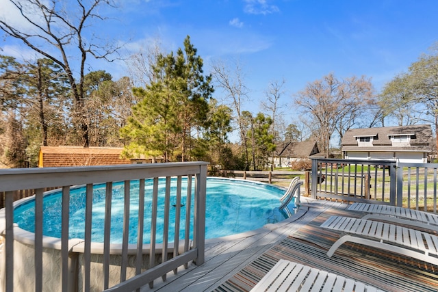 view of pool with a wooden deck