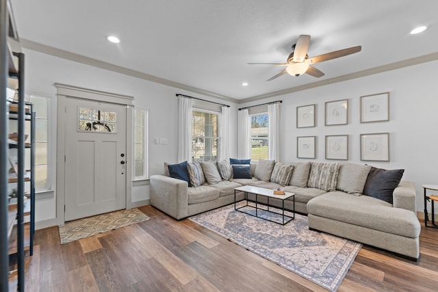 living area with recessed lighting, wood finished floors, and crown molding