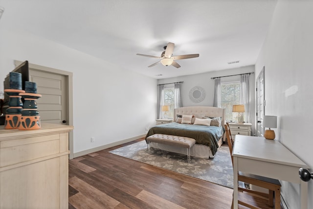 bedroom featuring ceiling fan, dark wood-style flooring, visible vents, and baseboards