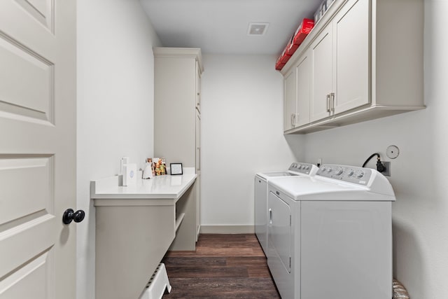 laundry area with cabinet space, baseboards, visible vents, dark wood-style floors, and separate washer and dryer