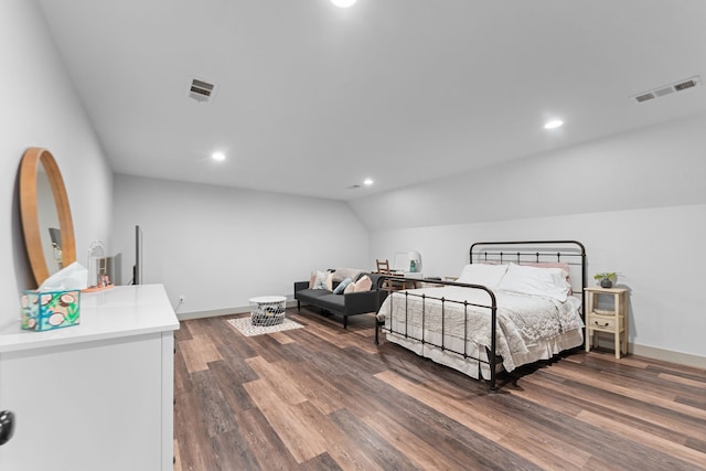 bedroom featuring lofted ceiling, visible vents, dark wood finished floors, and baseboards