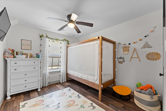 bedroom featuring ceiling fan, baseboards, and dark wood-style flooring