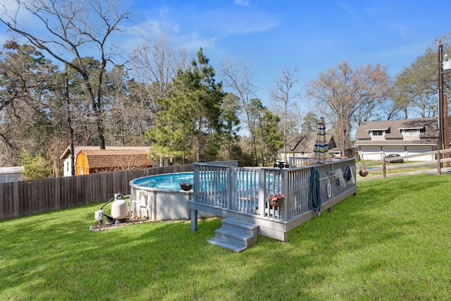 view of swimming pool with a deck, a lawn, a fenced backyard, and a fenced in pool