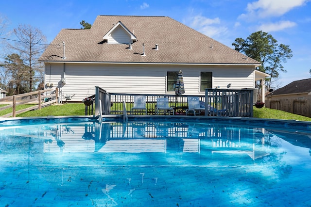 view of pool with a fenced in pool, a yard, fence, and a deck