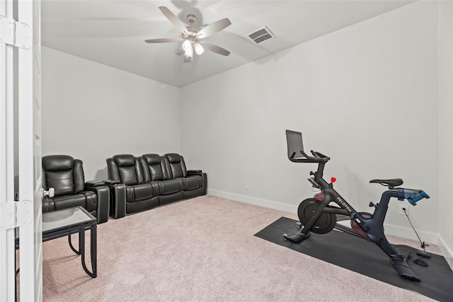 exercise room with carpet floors, baseboards, visible vents, and ceiling fan