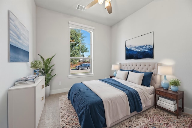 bedroom with a ceiling fan, light carpet, visible vents, and baseboards