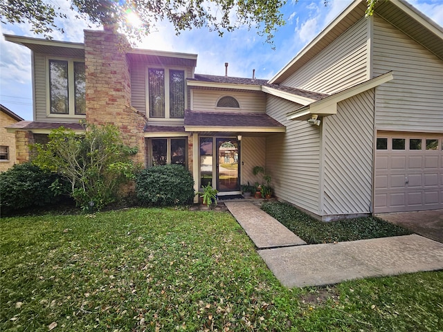 view of front of property with a garage, a front lawn, and a chimney