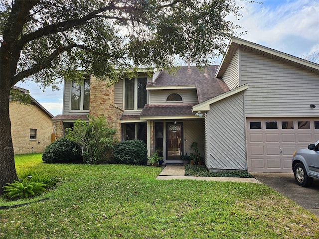 traditional home with roof with shingles, an attached garage, driveway, and a front lawn