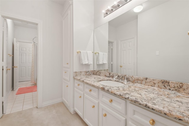 full bathroom featuring tile patterned floors, baseboards, and vanity