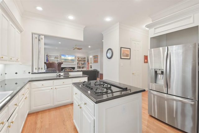 kitchen featuring appliances with stainless steel finishes, dark countertops, and white cabinetry