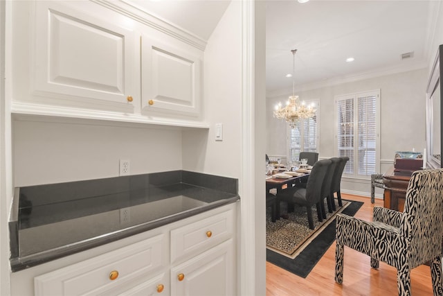 kitchen featuring dark countertops, white cabinetry, and light wood-style floors