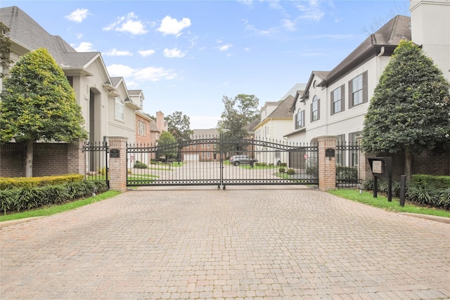 view of gate with a residential view and fence